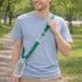 RPET 2 in 1 Water Bottle Lanyard - A drink bottle with a green lanyard strap is being worn by a man walking in a park. The lanyard features a logo.