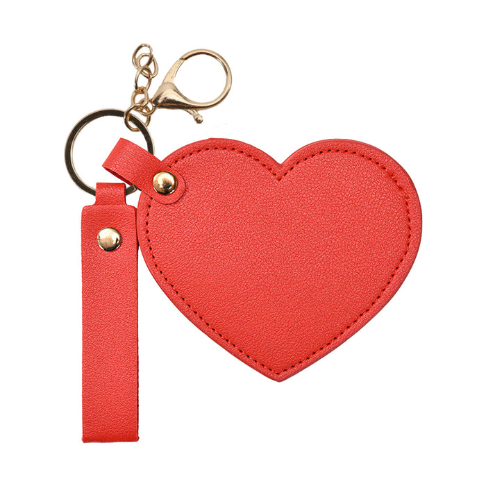 Heart-Shaped Compact Mirror with Keychain - A heart-shaped compact mirror in bright red, featuring a keychain and a clasp for easy attachment.