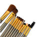 12-Piece Brush with Metal Box Set - A 12-piece brush set featuring various brushes with gold and silver handles in a metal box.