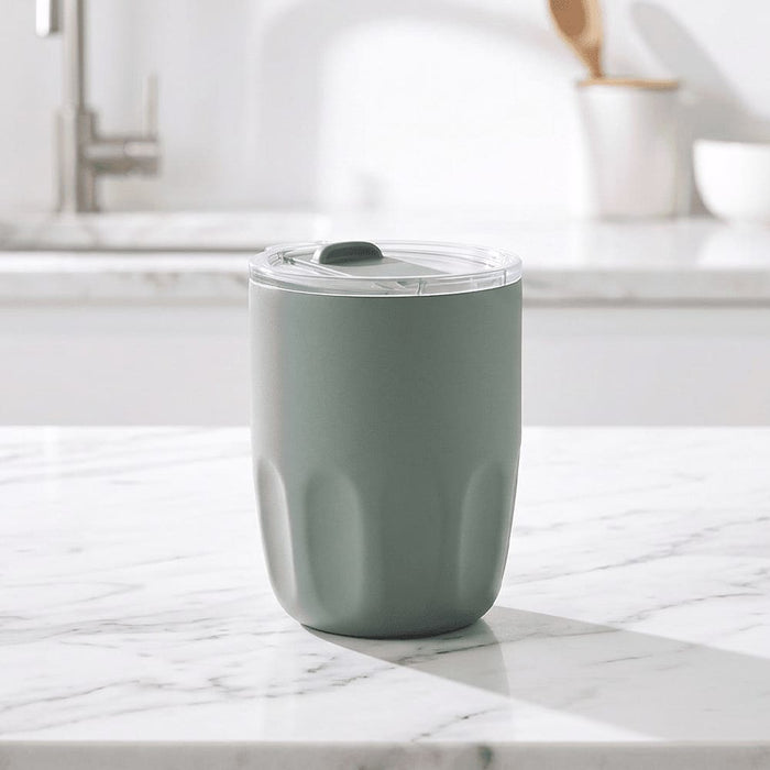 Carry Cup Olla Vacuum Coffee Cup w/ Ceramic Liner - 300ml - A drink bottle in a soft green hue with a clear lid, featuring a textured body and an internal ceramic liner.