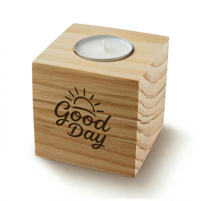 Wood Cube Candle - A wooden cube candle with a metal holder for a tealight, featuring a sun design and the words "Good Day".