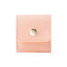 Mini Synthetic Leather Jewellery Bag - A pink mini synthetic leather jewellery bag with a snap closure and stitching detail. It features a small logo.