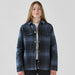 Women's Highland Sherpa Lined Plaid Jacket - A plaid jacket in navy and blue tones with a Sherpa lining and snap buttons. Features two chest pockets and a logo.