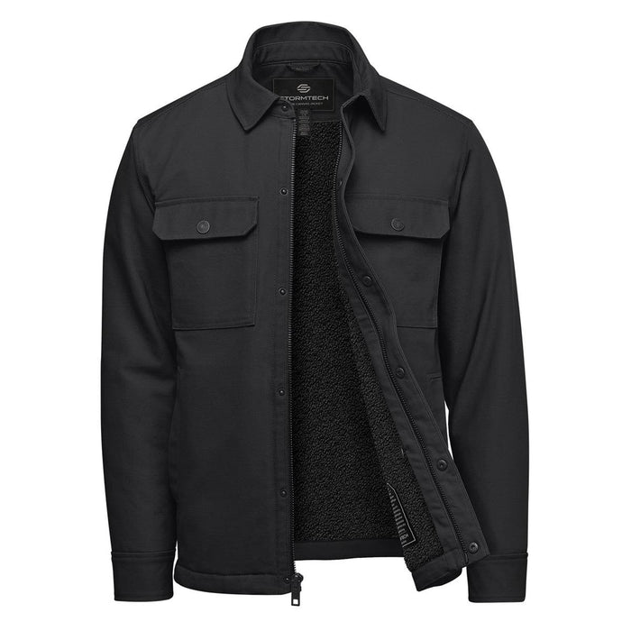 Men's Oxide Sherpa Lined Canvas Jacket - A black men's jacket with a sherpa lining, featuring buttoned chest pockets and a zip front. It has a logo on the inside.
