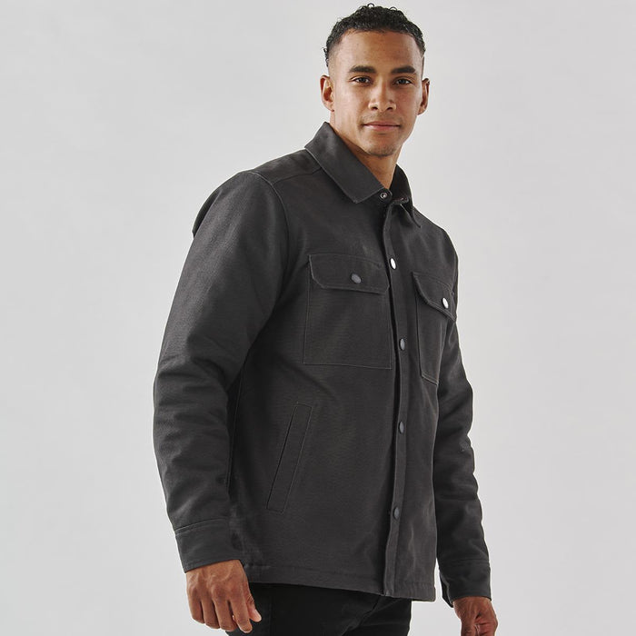 Men's Oxide Sherpa Lined Canvas Jacket - A men's dark grey canvas jacket with a Sherpa lining and two front pockets, featuring a button-up design and a logo.