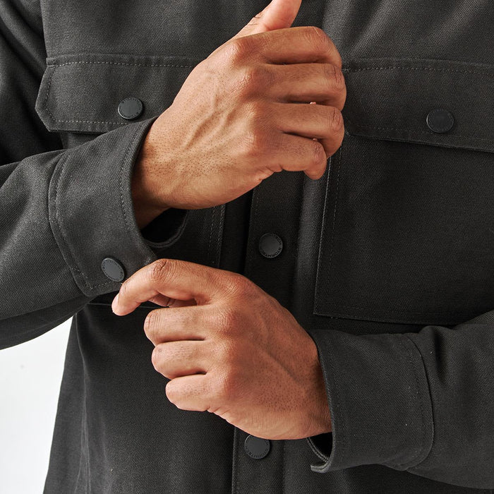 Men's Oxide Sherpa Lined Canvas Jacket - A men's dark grey oxford canvas jacket with a sherpa lining and snap-button closures on the cuffs and chest pockets.