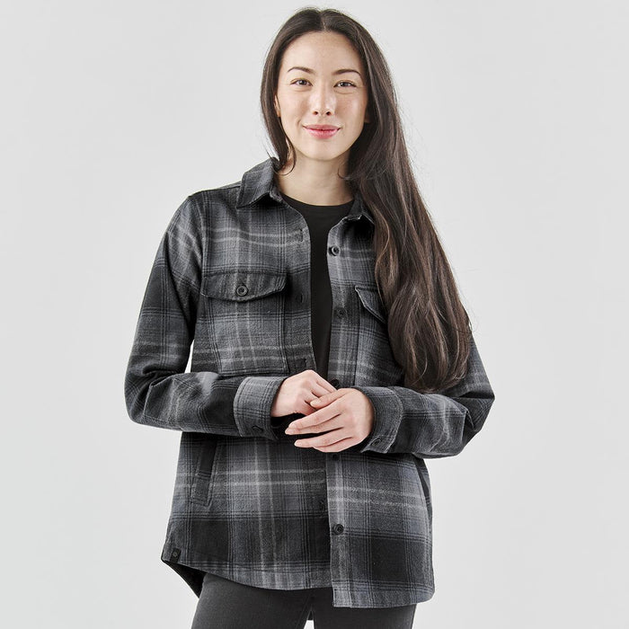 Women's Highland Plaid Shacket - A women's shacket in grey and black plaid, featuring a collared design and two chest pockets.