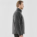 Men's Athabasca Thermal Jacket - A grey Men's Athabasca Thermal Jacket displayed on a male model, featuring a collar and a logo.