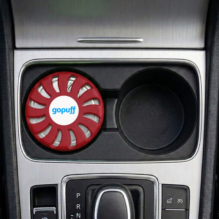 Air Freshener – Rose - A red air freshener sits in a car cup holder, featuring a logo on the front.