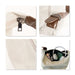 Dumpling Canvas Tote Bag - A beige canvas tote bag with brown accents, showcasing a zipper, strap detail, and interior contents including headphones and bottles.