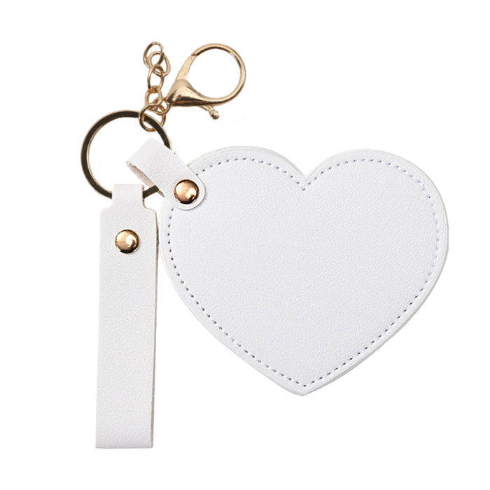 Heart-Shaped Compact Mirror with Keychain - A heart-shaped compact mirror in white with a keychain and a gold-coloured clasp. It features a simple design.