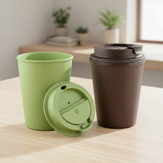 Karvo Kuppa – EcoBlend - A drink bottle set featuring a green cup and a brown tumbler with a lid, presented on a wooden table.