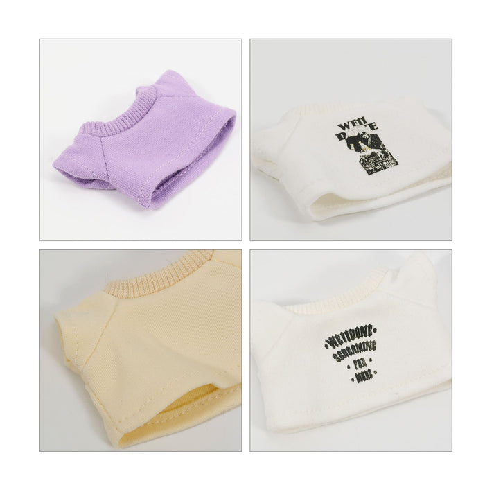 Plush Doll Basic T-Shirt - Two plush doll t-shirts in lavender and creamy white, featuring playful designs and a logo on each.