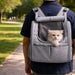 Pet Backpack Carrier with Expandable Design - A grey pet backpack carrier with an expandable design, featuring a mesh window and a cat peeking out.
