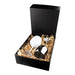 Bella Stainless Steel Wine Glas - A stainless steel wine glass with a black box and shredded paper filling, featuring a white wine glass alongside.