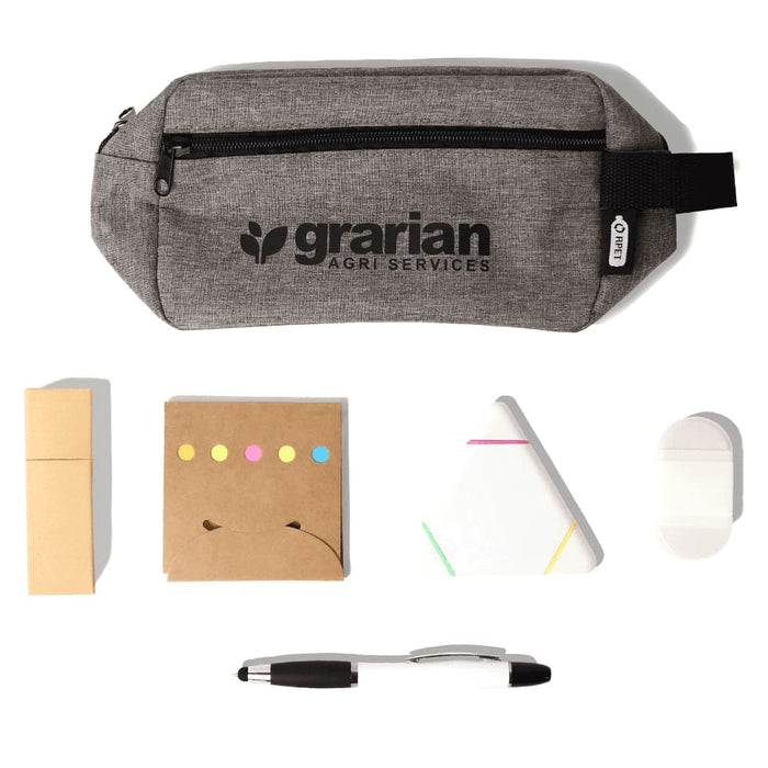 Stationary Essentials Pack - A grey pencil case with a logo contains sticky notes, a triangular notepad, a white eraser, and a black pen.