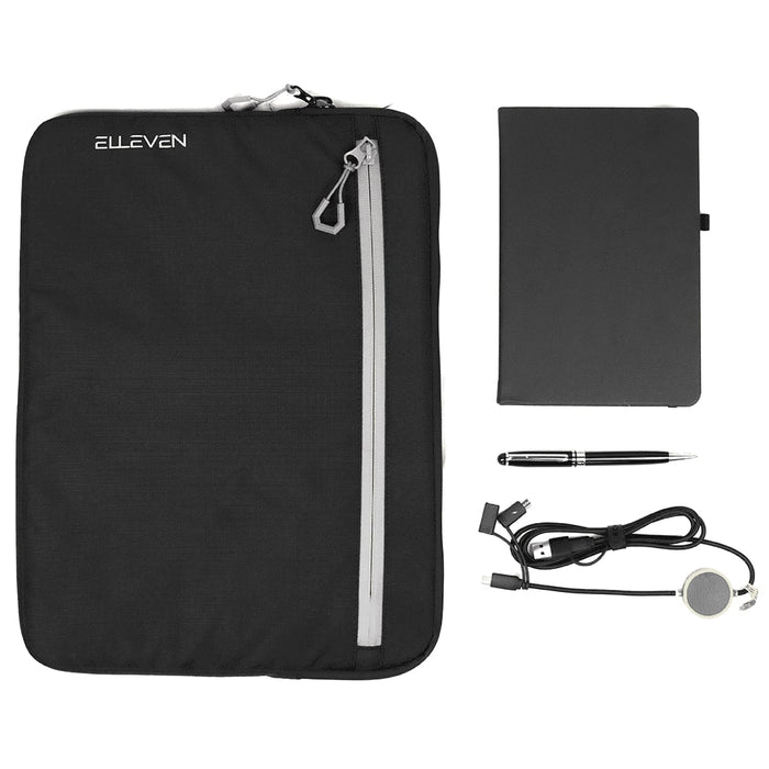 Work Essentials Pack - A black zippered pouch, a black notebook, a silver pen, and a charging cable with a circular connector. The pouch has a logo.
