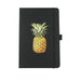 Lifestyle Essentials Pack - A black notebook featuring a pineapple illustration on the front cover. It has a strap closure and a ribbon marker.