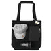 Lifestyle Essentials Pack - A black tote bag containing a grey cap, a notebook, a pen, and a glass tumbler.