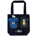 Lifestyle Essentials Pack - A navy tote bag holds a blue cap, a pineapple notebook, a pen, and a drink bottle, all featuring a logo.