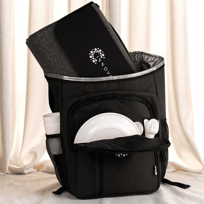 Picnic Pack - A black picnic backpack with a grey blanket, plates, cutlery, and a drink bottle in external pockets.