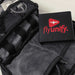 Branded Tech Kit Gift Pack - A black tech kit with compartments, featuring a wallet that has a logo and other tech accessories inside.