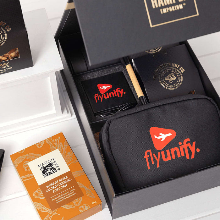 Branded Tech Kit Gift Pack - A black gift box contains a branded tech kit, featuring a black pouch, notebook, pen, and snacks.