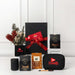 Branded Tech Kit Gift Pack - A black gift box tied with a red ribbon contains various items, including a drink bottle, a coffee pack, and a branded pouch.
