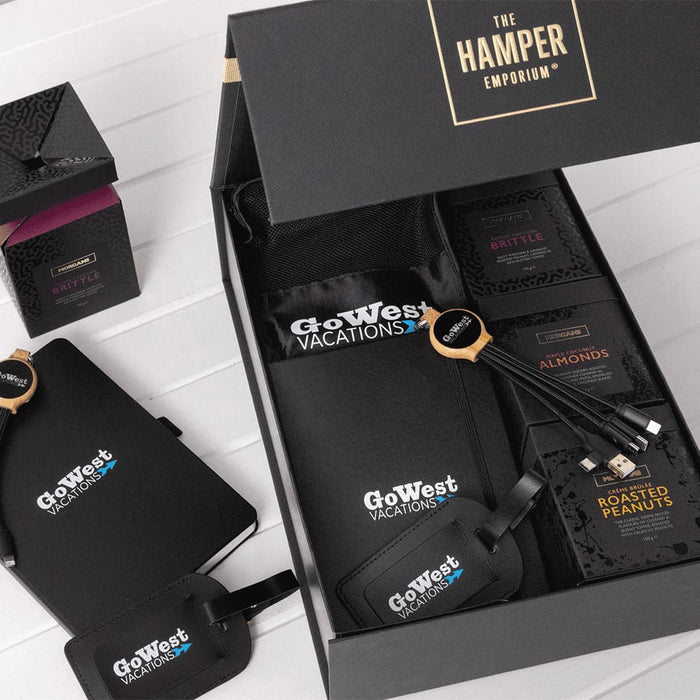 The Custom Travel Kit - A custom travel kit featuring a black bag, snack packs, luggage tags, and a logo.