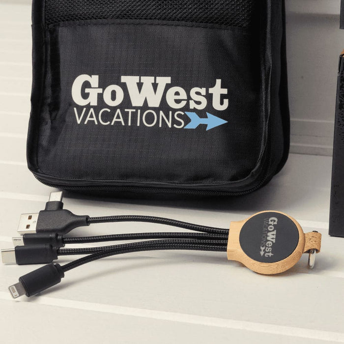 The Custom Travel Kit - A black travel kit with a logo, featuring a multi-cable charger with USB and other connectors.