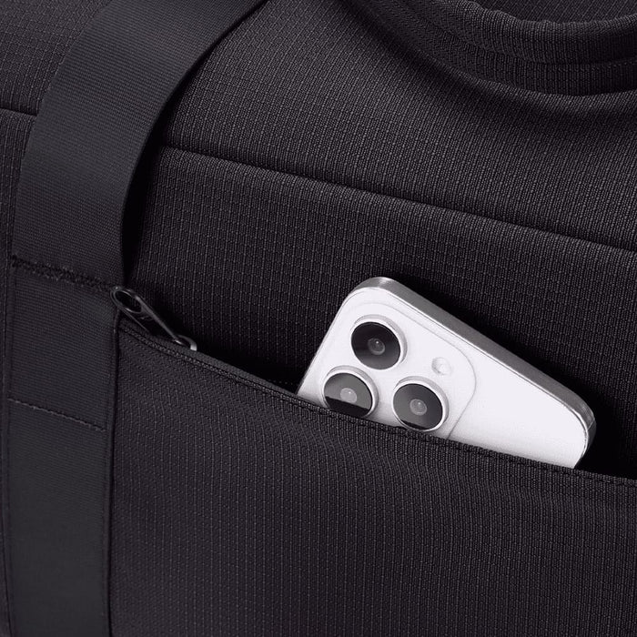 High Sierra Camille Duffel 31L - A black duffel bag features a zippered pocket with a smartphone partially visible inside.