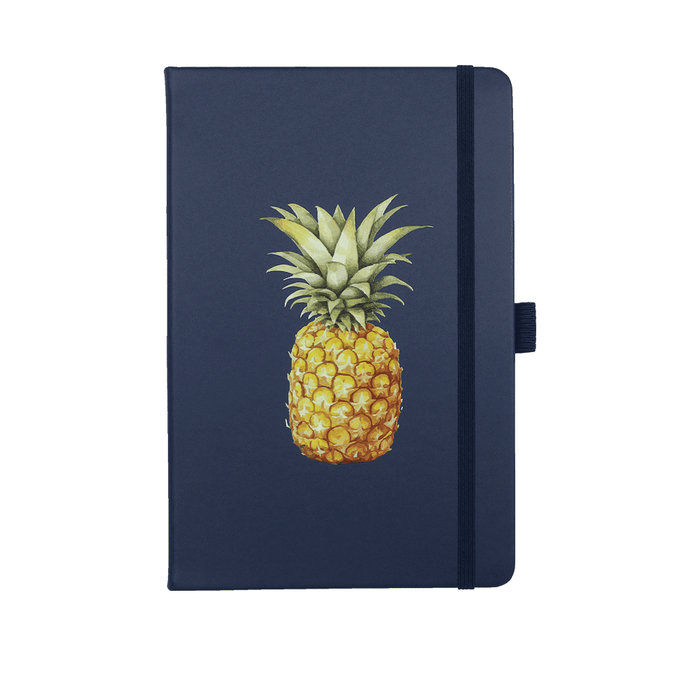 Lifestyle Essentials Pack - A navy journal with a pineapple illustration on the cover. It features an elastic band closure and has branding.