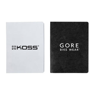 Koda Survival Notebook (Blank Pages) - Two notebooks, one with a white cover and a logo, the other with a black textured cover displaying a logo.