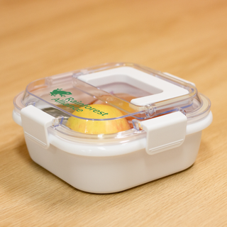 Pac-Man Lunch Box with Handle - A white lunch box with a clear lid, featuring a green logo and a secure clip closure.