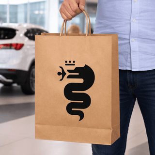 Paper Show Bag - A brown paper show bag with a black logo featuring a snake. The bag is being held by a person in casual attire.