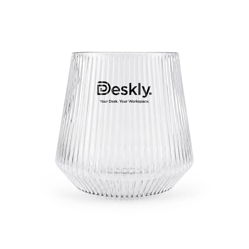Velora Tumbler by The Line Edit. - A clear glass tumbler with ribbed texture and a logo at the front.