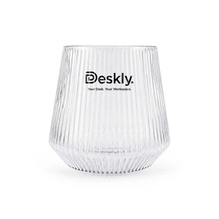 Velora Tumbler by The Line Edit. - A clear glass tumbler with ribbed texture and a logo at the front.