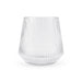 Velora Tumbler by The Line Edit. - A clear, ribbed glass tumbler with a wide base and flared shape. It features a subtle logo on the surface.