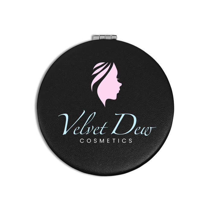 Finesse Compact Mirror - A round black compact mirror featuring a logo with a profile silhouette and "Velvet Dew Cosmetics" text.