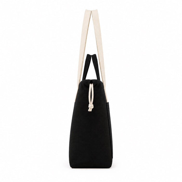 Darby Tote Bag - A black tote bag with cream straps and a drawstring closure. The bag has a simple design and features a logo.