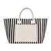 The Good Stuff Pack - A striped tote bag in black and white with a plain cream-coloured front pocket and handles. It has a logo.