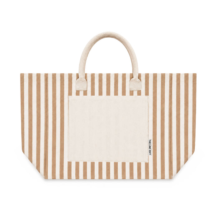 Hampton Tote Bag by The Line Edit. - A large tote bag featuring horizontal stripes in beige and cream, with a solid pocket and handles.