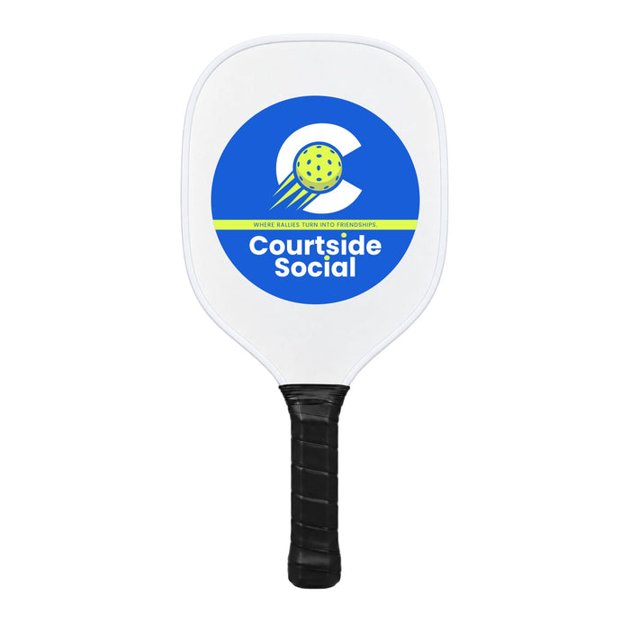 Matchpoint Pickleball Set - A white pickleball paddle with a circular logo featuring a yellow ball and blue accents. It has a black grip.