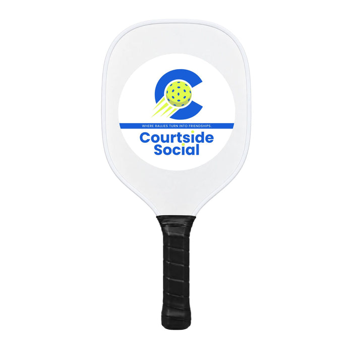 The Play & Graze - A white pickleball paddle with a black handle and a logo featuring a green ball and blue text.