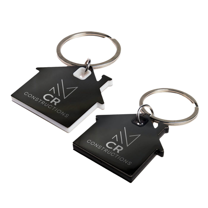 House Stainless Steel Keytag - Two house-shaped keytags in black and white, featuring a keyring and a logo on each.