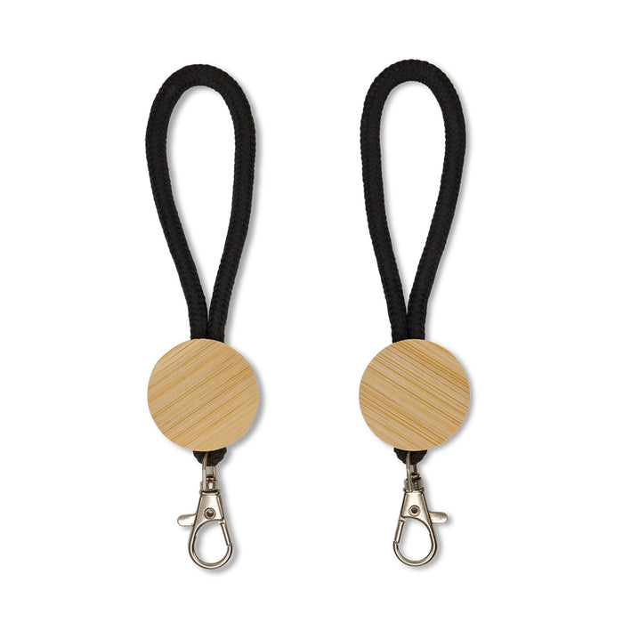 Luxeloop Keytag - A keytag featuring a round wooden element with a black rope attachment and a metal clip.