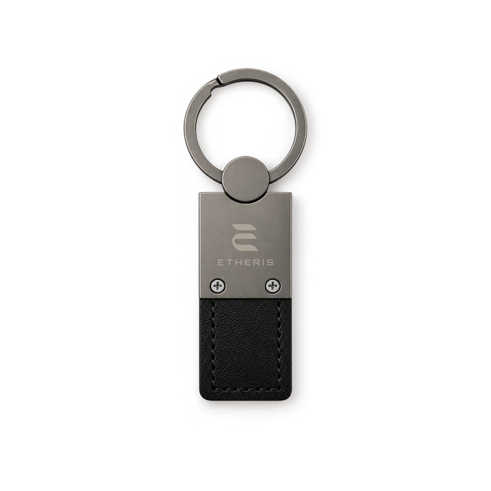 Mario Keytag - A black leather keytag with a metal key ring and a logo embossed on the metal section.