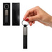 Zander Keytag - A hand holds a sleek black Zander Keytag with a metal ring and rectangular body. It comes in a black box.
