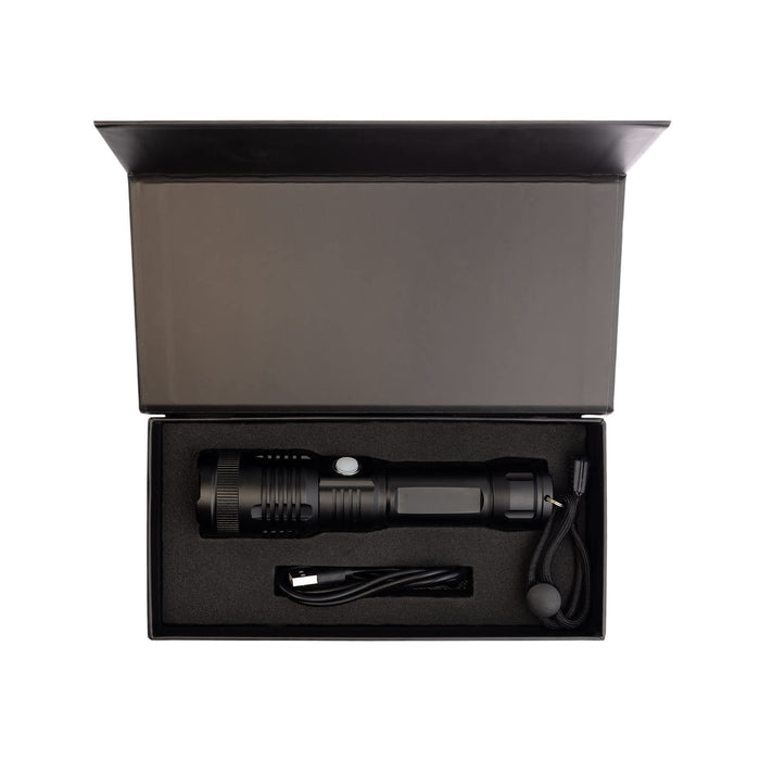 Lumi Rechargeable Torch - A black rechargeable torch in a black box with a USB charging cable and a lanyard. The box is open.
