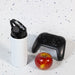 Amore 500ml Junior Bottle - Flip Straw Lid - A drink bottle featuring a flip straw lid, alongside a red apple and a black gaming controller.